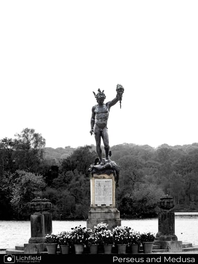 A Statue of Perseus holing the head of medusa in black and white