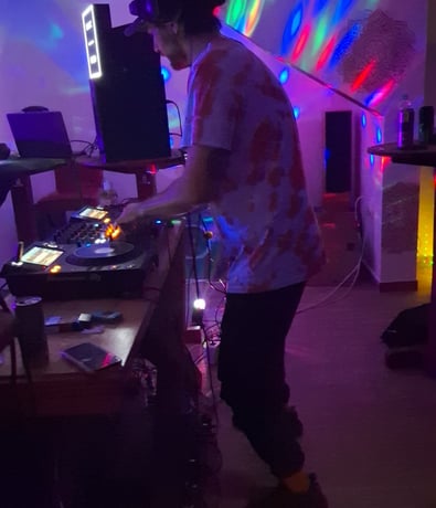 a man in a room with a dj booth