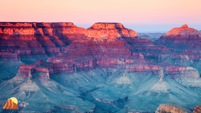 a cliff overlooking a vast view of the grand canyon