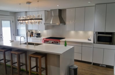 a kitchen with a large island and a bar stool