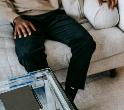 a man and woman sitting on a couch in a living room