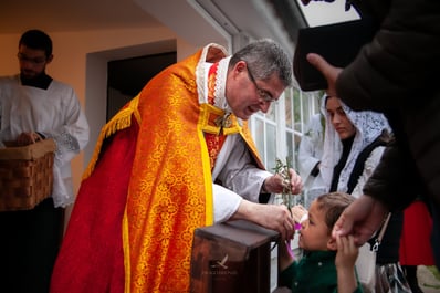 Fsspx priest blessing child on palm sunday