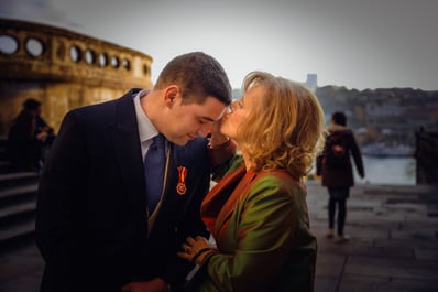 mother kissing the groom in porto