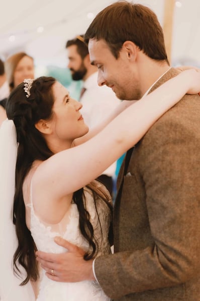 bride and groom smiling at each other during their first dance