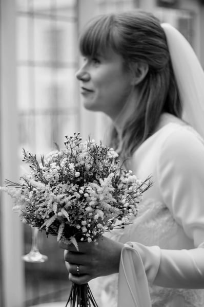 beautiful black and white photo of a bride holding flowers on her wedding day