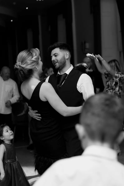 beautiful black and white photo of a man and woman dancing at a wedding