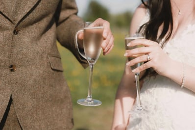 Bride and Groom share a glass of champagne