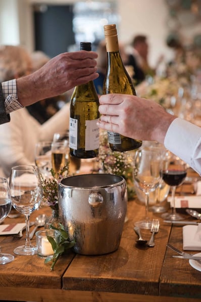 Wedding guests sampling wine at the dinner table