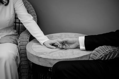 Black and White wedding photo of bride and groom holding hands