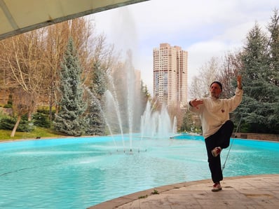 Harun Mehmet Soydan flows beside the fountain’s arc, stillness rippling through the city’s quiet breath.