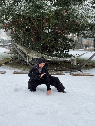 Mine Şillliler moves in silent strength as snow falls