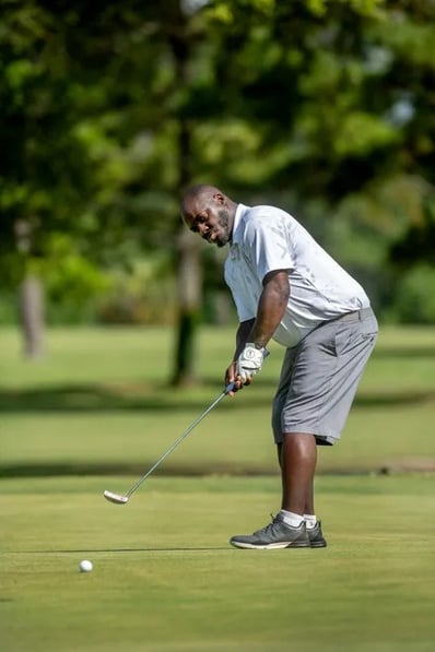 Par Four Golf Club image of Byrd Stallworth putts on the fourth green during the final day of the Calvin Washington Memorial