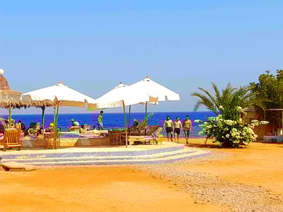 People enjoying their holiday araound the pool at Bedouin star Ras shitan Nuweiba Egypt