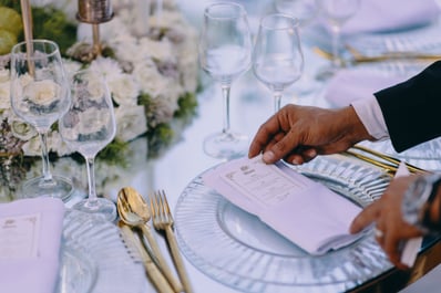man adjusting menu on a table