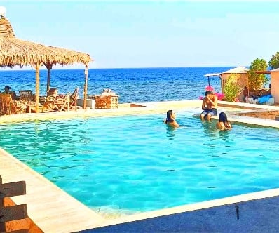 People in the pool with sea view at Bedouin star Ras shitan Nuweiba Egypt