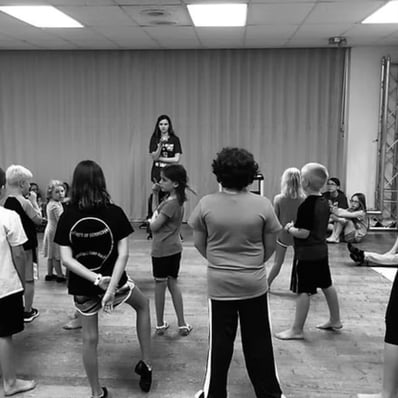 Youth director directing child actors in an adaptation of a play for KidWorks Festival.