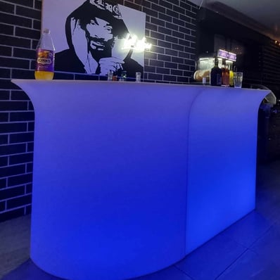 Glowing bar with a Snoop Dog behind the bar and the slushie machine in the background, Redlands.