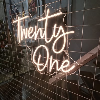 Twenty One neon sign lit up to match the gold theme at Kaea's 21st birthday party in Brisbane.