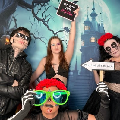 Guests posing in the Halloween themed digital photo booth at a party in the Redlands.