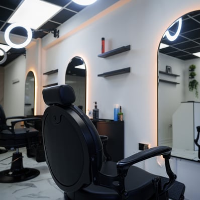 Inside of empty clean and new barbershop, chairs mirrors and LED accent lights