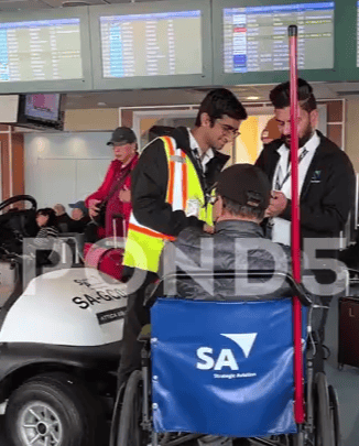 A screengrab from a stock video, which shows me assisting a wheelchair guest