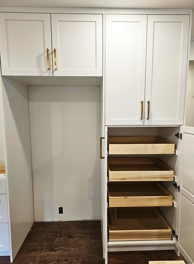 a kitchen with a pantry with white shaker cabinets and drawers