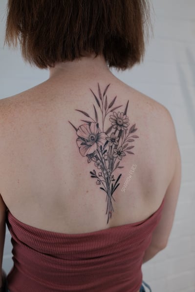 Fineline flower bouquet tattoo on the back