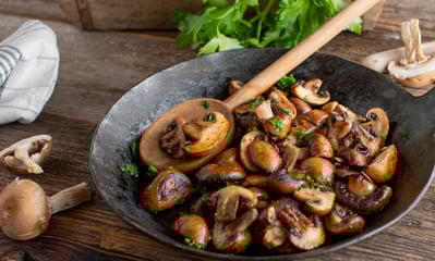 a pan of mushrooms and mushrooms in a skillet