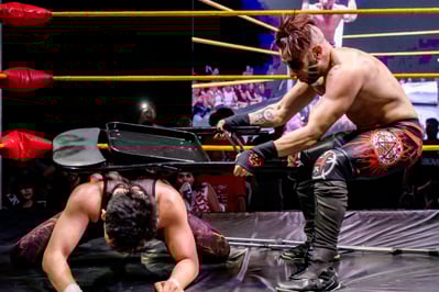 The British Horror pounds Khoa Truong with a chair during the Devil's Playground match