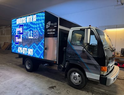 PXLLED mobile LED billboard truck with full-panel digital signage promoting advertising services. 