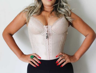 a woman in a white top and black pants