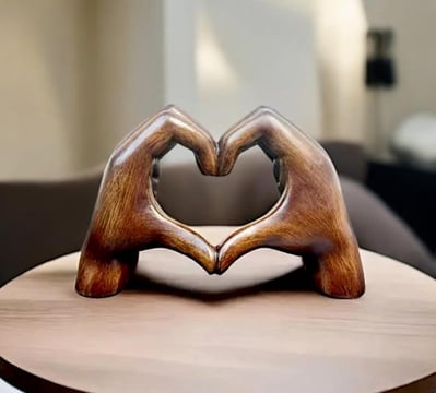 a wooden heart shaped sculpture on a table