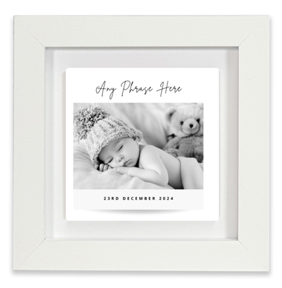 a baby's birth announcement card with a baby in a white frame