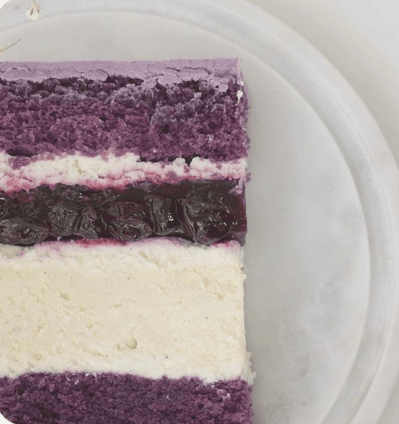 a piece of cake with a purple and white background