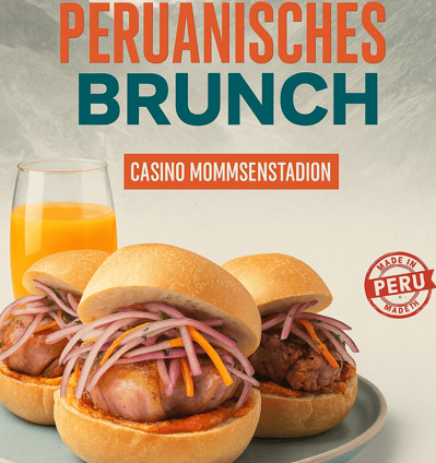 a plate with two sandwiches and a glass of orange juice