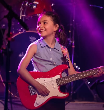 Gurnee Guitar Academy Guitar Lessons a girl with a guitar and a guitar