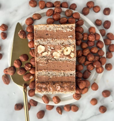 a piece of cake with nuts and nuts on a plate