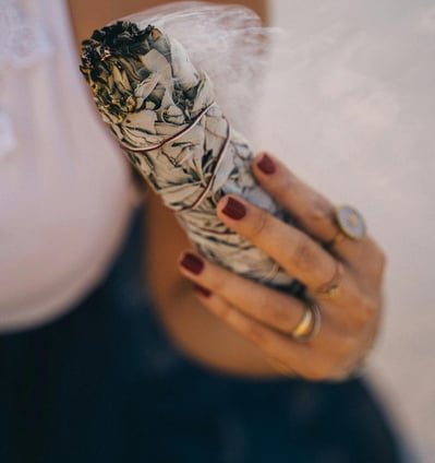 herbal smudge and a hand