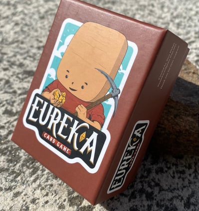 Eureka the mining card game deck on a rock table
