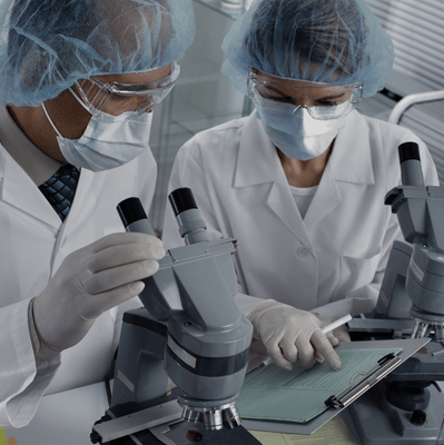 two people in lab coats and surgical masks