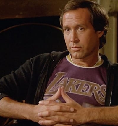 a man in a purple shirt and a black jacket