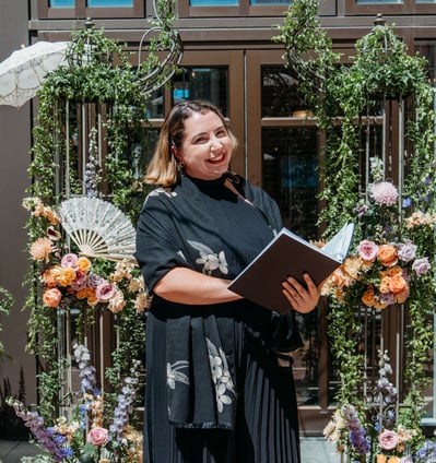 Photo of Officiant in fron of Floral Arbor