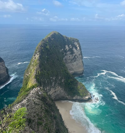 a person standing on a cliff overlooking a body of water