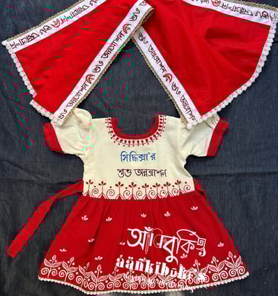 a baby girl's dress with a red and white dress
