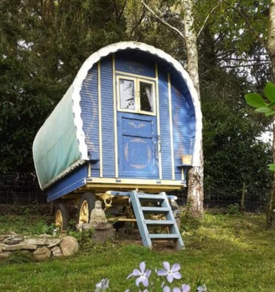 Charming blue bow top roulotte set in a peaceful forest clearing at Les Vieilles Forges