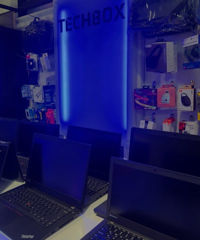 a row of laptops with a blue light on the wall