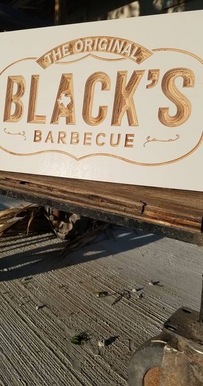 a custom made wooden sign that says black's barbequequee