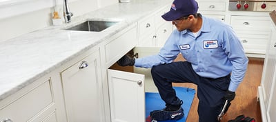 Plumber using Garbage Disposal