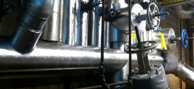 Licensed lead abatement team conducting lead pipe removal and testing in commercial building