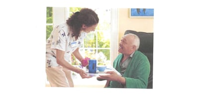 a home health aide and a client in a home.